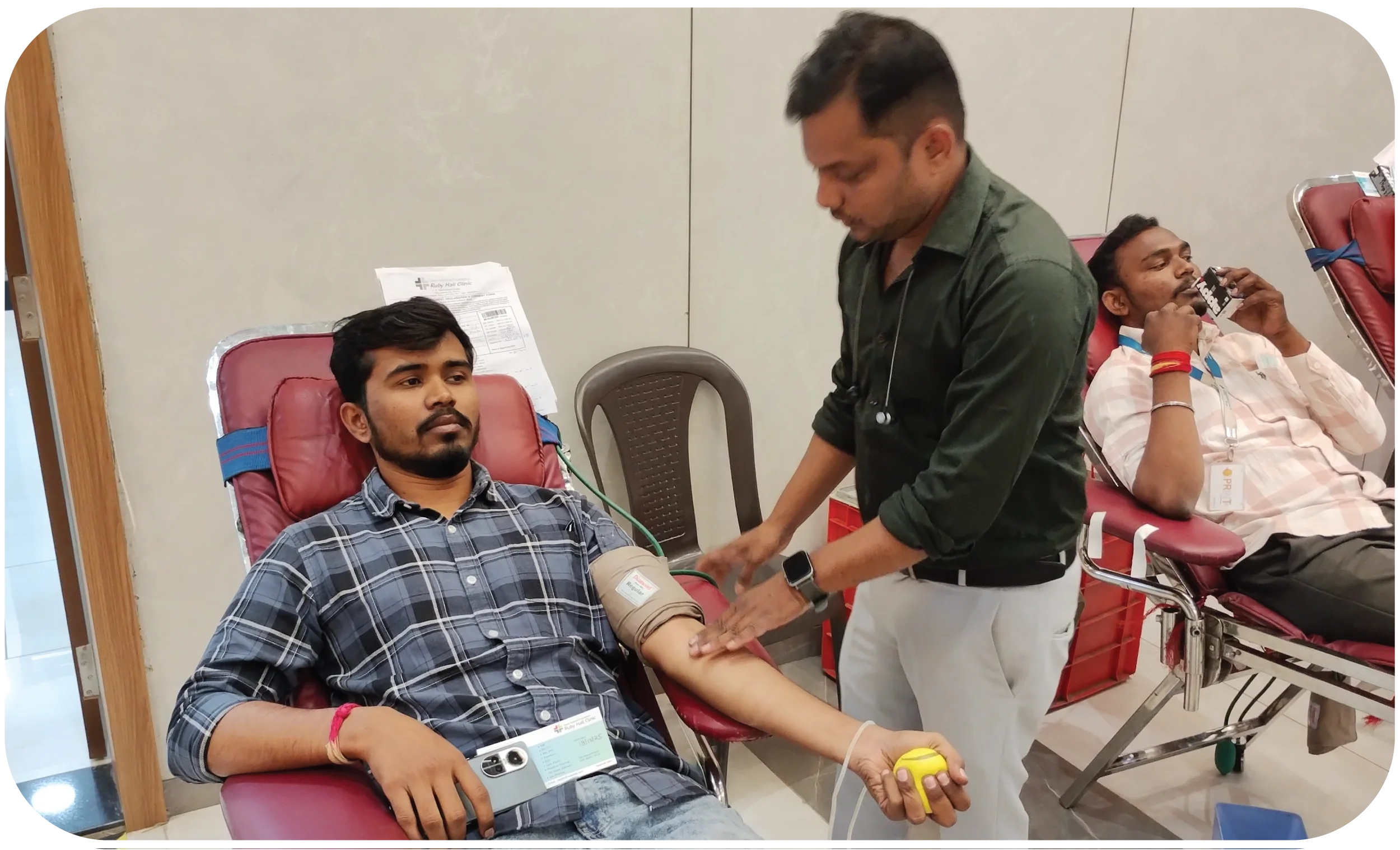Doctor checking blood pressure and screening donor before donation